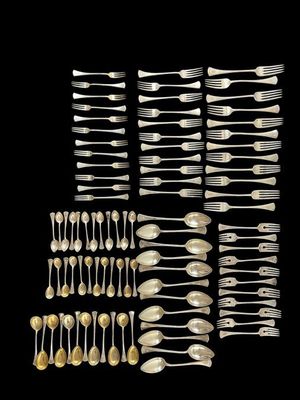 a group of silverware including forks and spoons on a black background