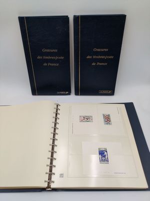 two books on a white table with a black cover and a blue cover