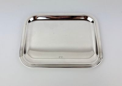 a silver tray on a white surface with a handle
