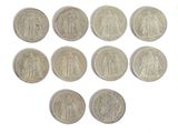 six different types of silver coins on a white surface