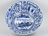 blue and white porcelain bowl with a landscape scene in the center