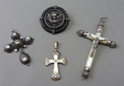 three crosses, a clock, and other religious items are on a table