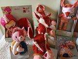 many stuffed animals that are sitting in boxes on the floor