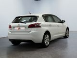 the rear end of a white car parked in a garage