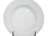 a white plate on a metal stand on a white background