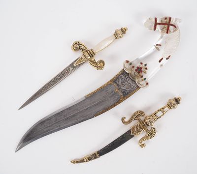 three different types of daggers are displayed on a white surface