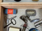 a drawer with various items in it on the floor