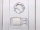 a white box with a charger and a cable attached to it