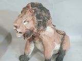 une statue représentant un lion assis sur une table
