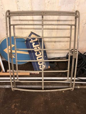 a metal rack with a sign and a skateboard on it