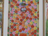 many framed pictures of flowers on the wall