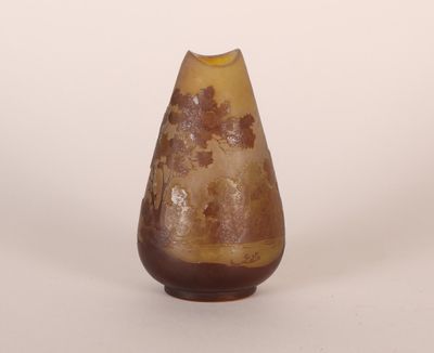 a brown vase with a yellow top on a white surface