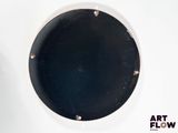 a black and white picture of a round object on a white surface