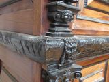 a statue of a woman on top of a wooden door