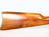 a close up of a rifle on a white surface with a white background