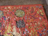 a red rug with a picture of a cat on it