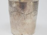 a silver cup that is sitting on a table
