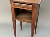 an old wooden table with a drawer on top of it