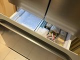 a refrigerator that has a drawer in the middle of it