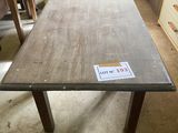 a wooden table with a sticker on it in a room
