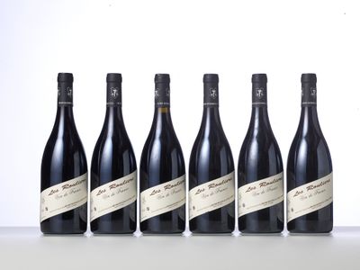 six bottles of wine lined up in a row on a table