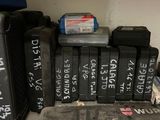 a lot of black suitcases sitting on a shelf
