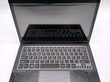 a black laptop with a silver keyboard on a white surface
