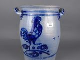 an old blue and white vase with a rooster on it