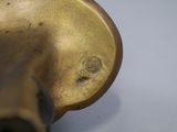 a close up of a brass object on a table