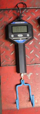 a digital scale that is hanging on the wall