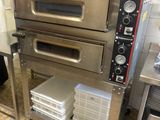 three ovens stacked on top of each other in a kitchen
