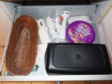 a hair dryer, a brush, and other items in a drawer