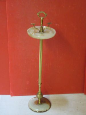 a small table with a gold stand and a red wall
