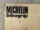 a cardboard sign that says michel bibagrip on it