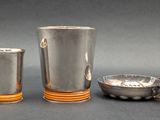 two cups and a spoon sitting next to each other on a table