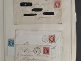 two old envelopes with stamps on them sitting on top of a table