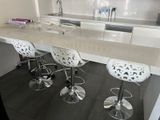 a picture of a kitchen with a counter and stools