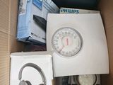a box with a clock, headphones, and other items in it