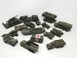 many army vehicles that are sitting on a white surface