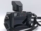 a black camera with a black strap on a white background