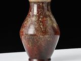 a brown vase sitting on a white table