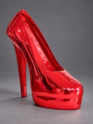 a red high heeled shoe on a grey background