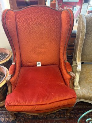 an image of a red chair sitting in a room next to a table