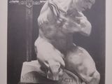 black and white photograph of a statue of a man holding a sword