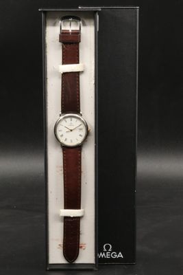 a close up of a watch in a box on a black surface