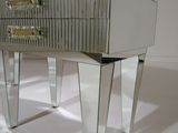 a mirrored table with a drawer on top of it
