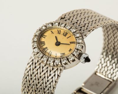 a close up of a wrist watch with roman numerals on it