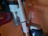 a vacuum that is sitting on the floor next to a canister
