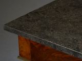 a table with a marble top and a wooden base