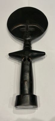 a black object on a white surface with a white background